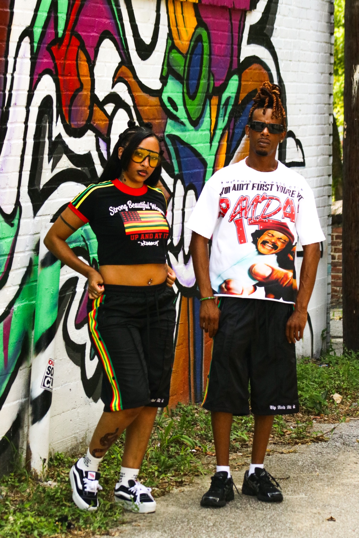 Two models in the Paid In Full tee and Freedom crop tee