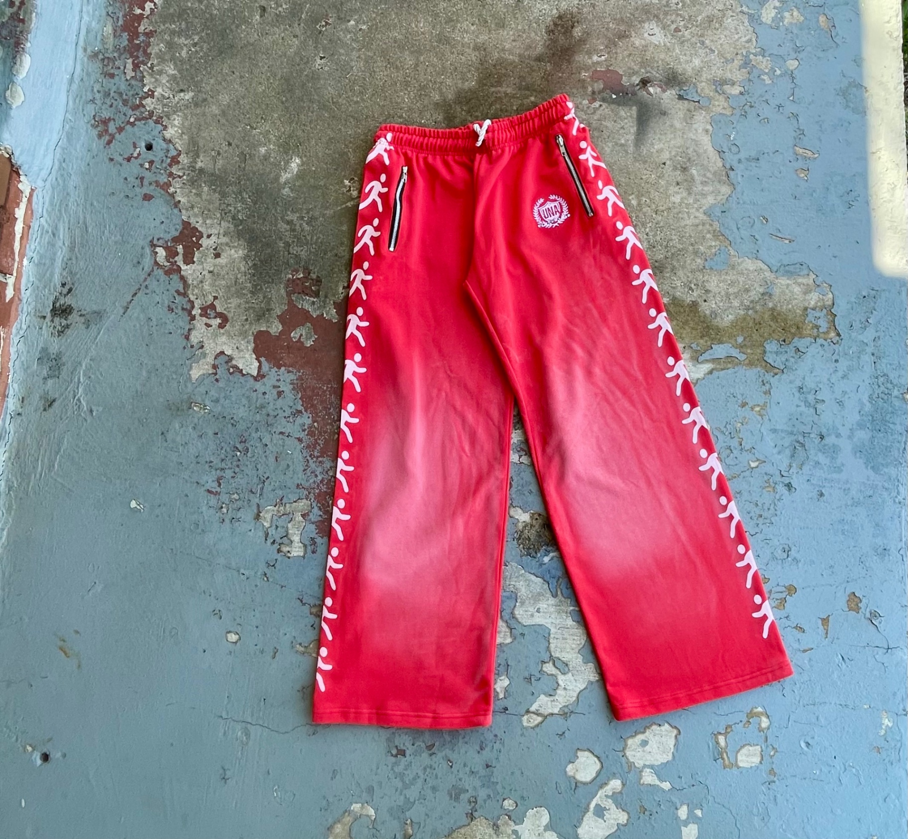 Red Runner track pants with repeating white figures