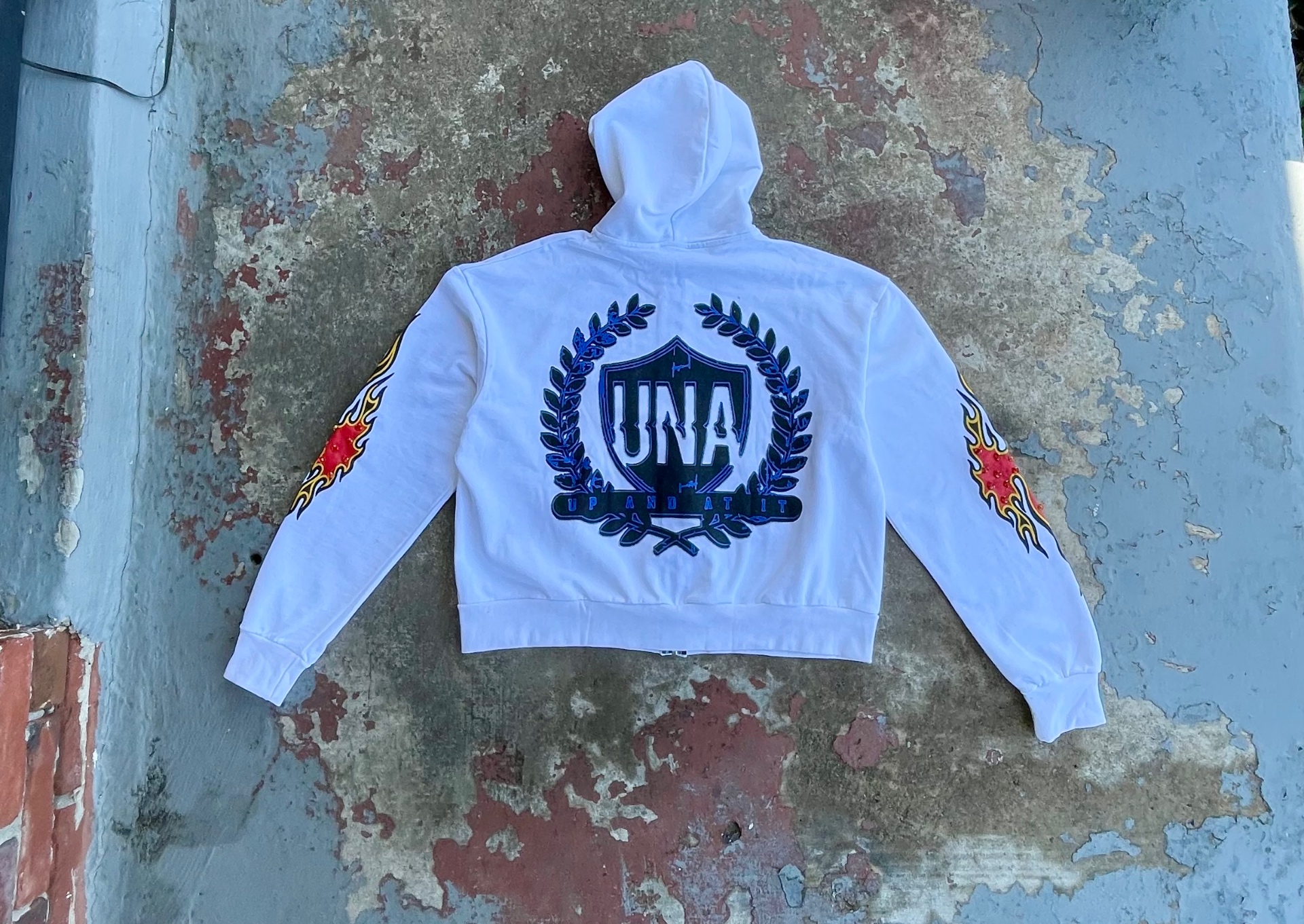 White UNA Crest zip hoodie with flame sleeves